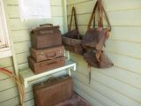 Old school bags and cases hanging in the old school building at Loxton's Historical Village